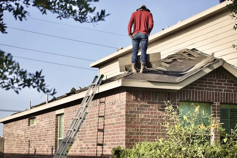 Professional roofer working on a residential roof in East Pyron